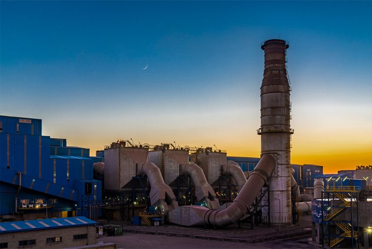 دودکش کارخانه اپال در مقابل افق طلایی شامگاهی